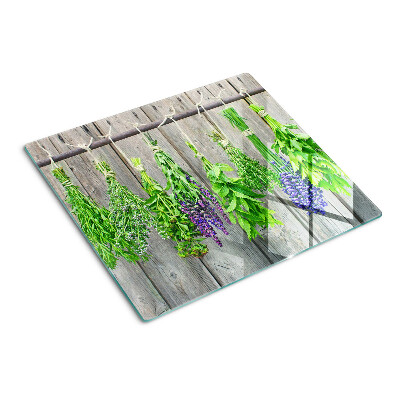 Tagliere in vetro Erbe essiccate su uno sfondo di legno