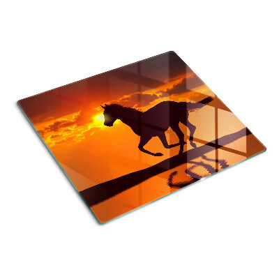 Tagliere in vetro Un cavallo sullo sfondo del sole al tramonto