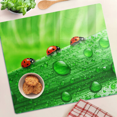 Tagliere in vetro Coccinelle su sfondo verde