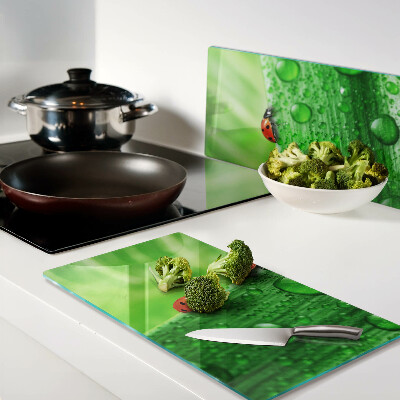 Tagliere in vetro Coccinelle su sfondo verde