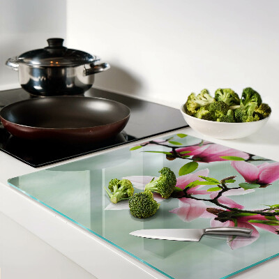 Tagliere in vetro temperato Fiori di magnolia su uno sfondo di verde