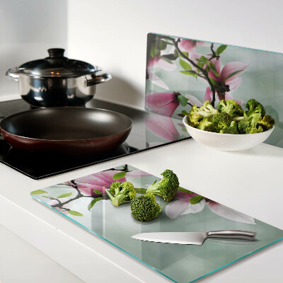 Tagliere in vetro temperato Fiori di magnolia su uno sfondo di verde