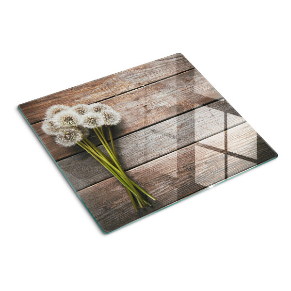 Tagliere in vetro temperato Fiori di tarassaco su uno sfondo di legno