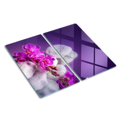 Tagliere in vetro Fiori di orchidea su uno sfondo di pietre