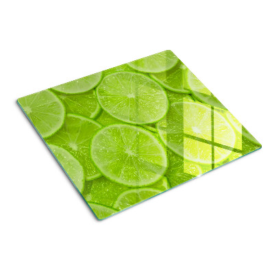 Tagliere in vetro Fette di lime su sfondo verde