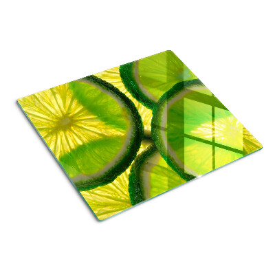 Tagliere in vetro temperato Fette di lime su sfondo verde