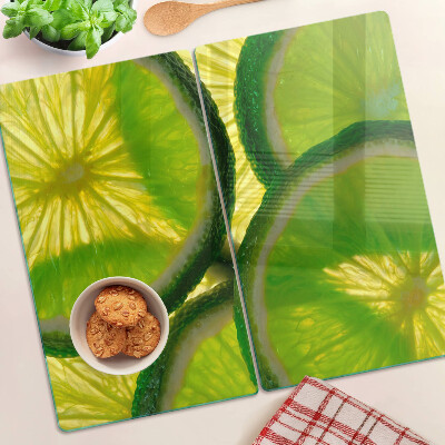 Tagliere in vetro temperato Fette di lime su sfondo verde