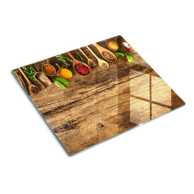 Tagliere in vetro temperato Spezie ed erbe aromatiche su fondo in legno