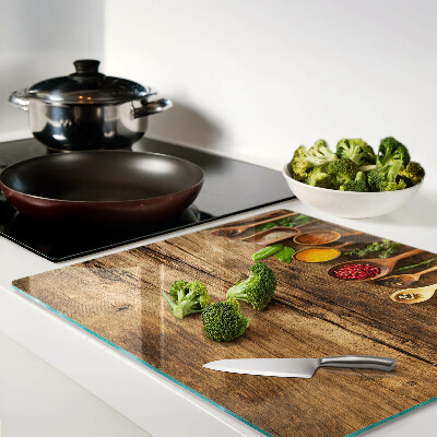Tagliere in vetro temperato Spezie ed erbe aromatiche su fondo in legno