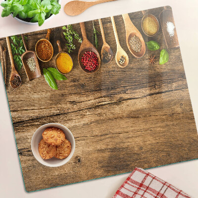 Tagliere in vetro temperato Spezie ed erbe aromatiche su fondo in legno