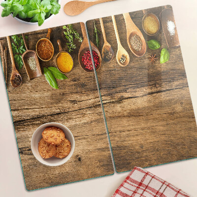 Tagliere in vetro temperato Spezie ed erbe aromatiche su fondo in legno