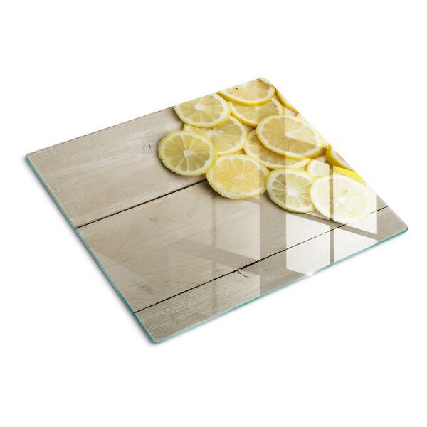 Tagliere in vetro Fette di limone su uno sfondo di legno