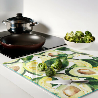 Tagliere in vetro temperato Avocado su uno sfondo di foglie