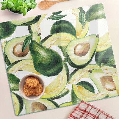 Tagliere in vetro temperato Avocado su uno sfondo di foglie