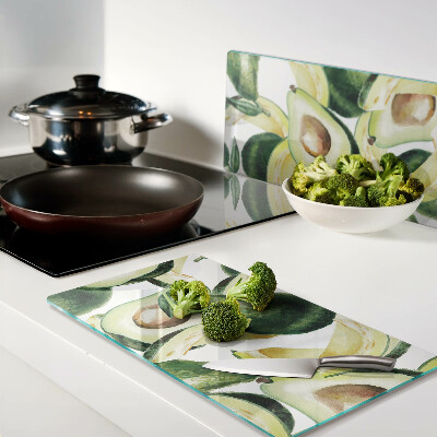 Tagliere in vetro temperato Avocado su uno sfondo di foglie