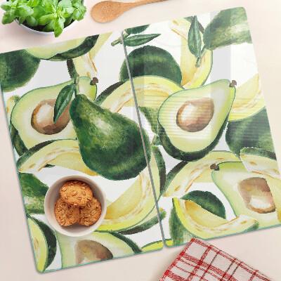 Tagliere in vetro temperato Avocado su uno sfondo di foglie
