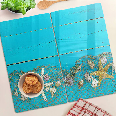 Tagliere in vetro Conchiglie e stelle marine in una rete