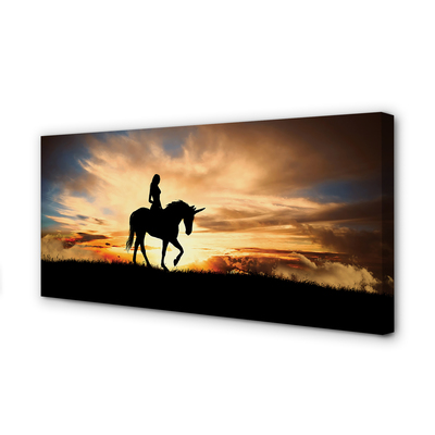 Quadro stampa su tela Una donna su un tramonto unicorno