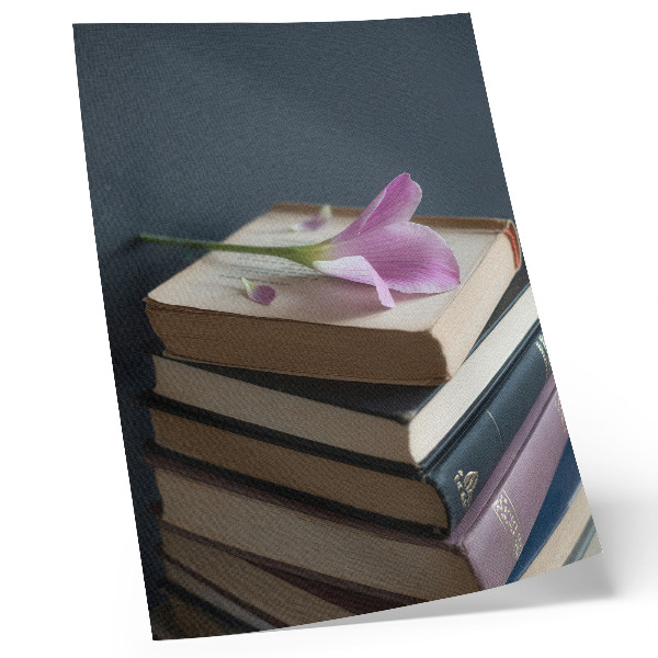 Stampa su tela Una pila di libri con un fiore delicato in cima