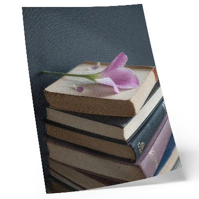 Stampa su tela Una pila di libri con un fiore delicato in cima