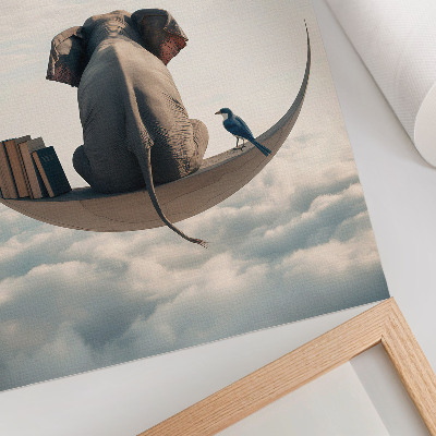 Foto su tela Un elefante su una falce di luna con libri tra le nuvole.