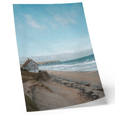 Stampa su tela Spiaggia, onde, casa sulla scogliera, colori pastello