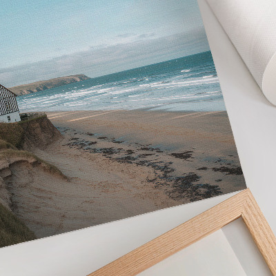 Stampa su tela Spiaggia, onde, casa sulla scogliera, colori pastello