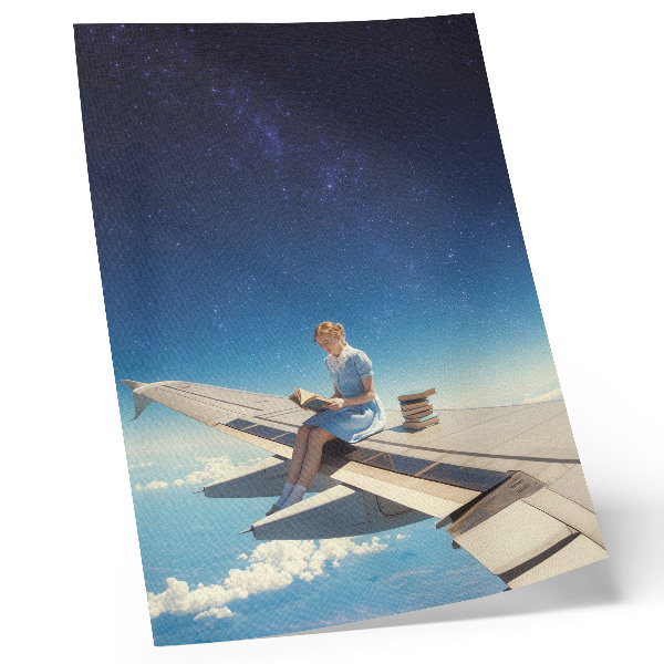 Foto su tela Libri dell'universo della ragazza sull'ala di un aereo