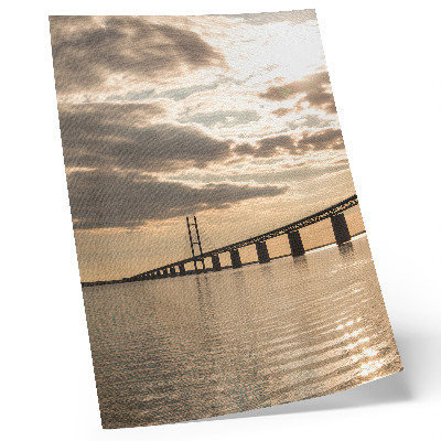 Stampa su tela Un ponte sull'acqua alla luce del sole al tramonto