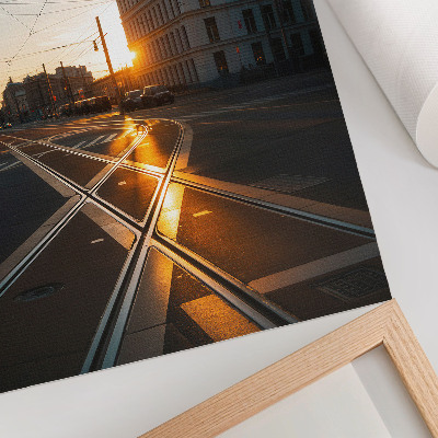 Foto su tela Il sole che tramonta sulla città con l'architettura