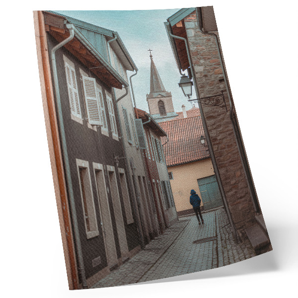 Poster Via stretta, case popolari, torre, cappotto blu