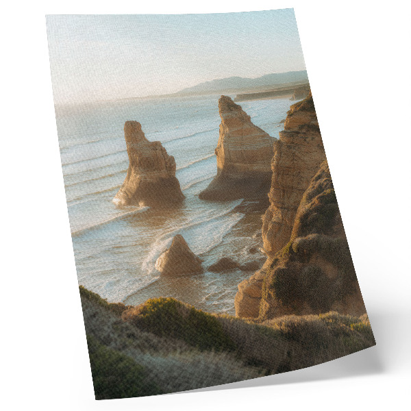 Foto su tela Scogliere rocciose al tramonto sul mare