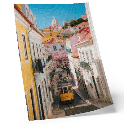 Stampa su tela Una strada con un tram, case popolari color pastello, fiori