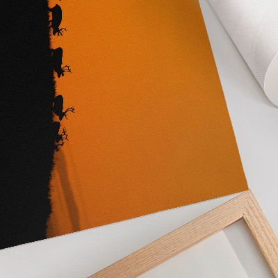 Poster Sagome di cervi su una collina con sfondo arancione